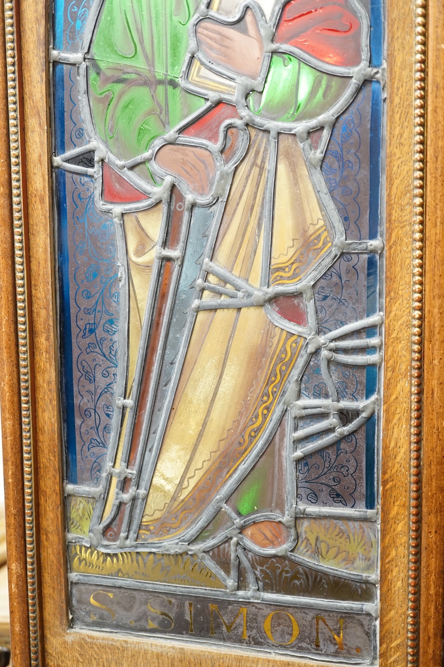 A pair of Victorian framed stained glass panels of St. Martin and St. Simon. 68.5cm tall